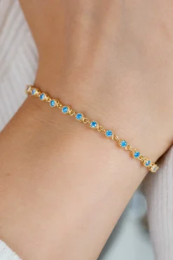 ZINZI gold plated zilveren armband met een speelse rij blauwe zirkonia’s in ronde zetting 3mm breed ZIA2893BG
